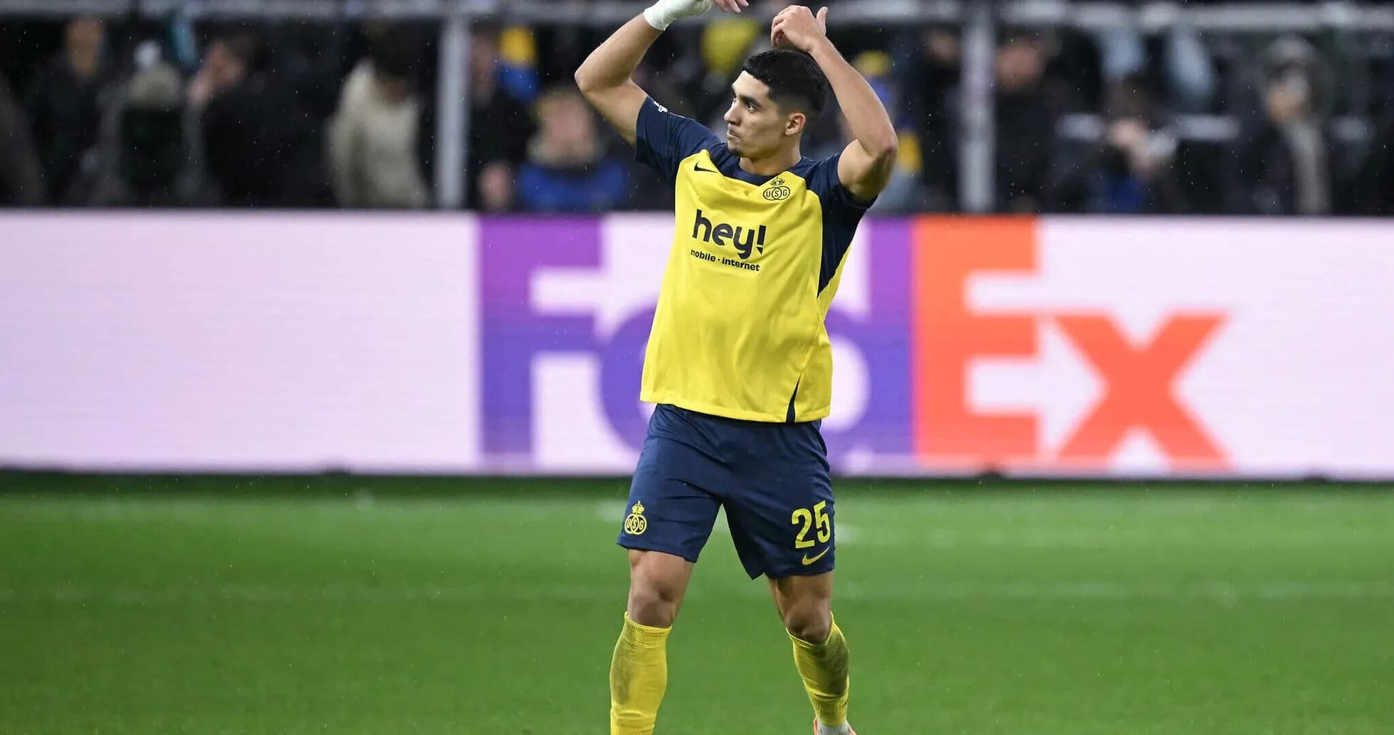 Player celebrating during a match with fans Player celebrating during a match with fans