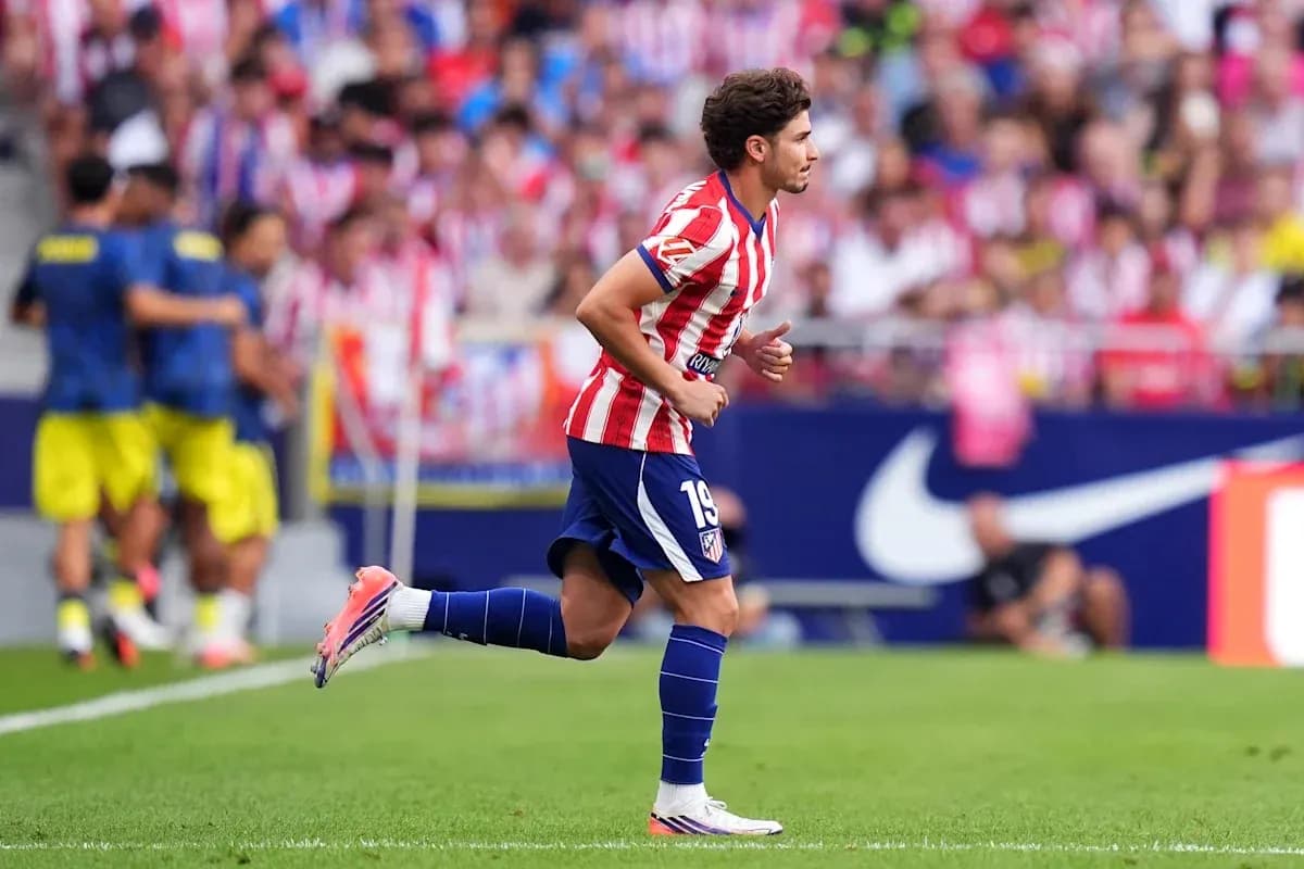 Atletico Madrid player running on the pitch Atletico Madrid player running on the pitch