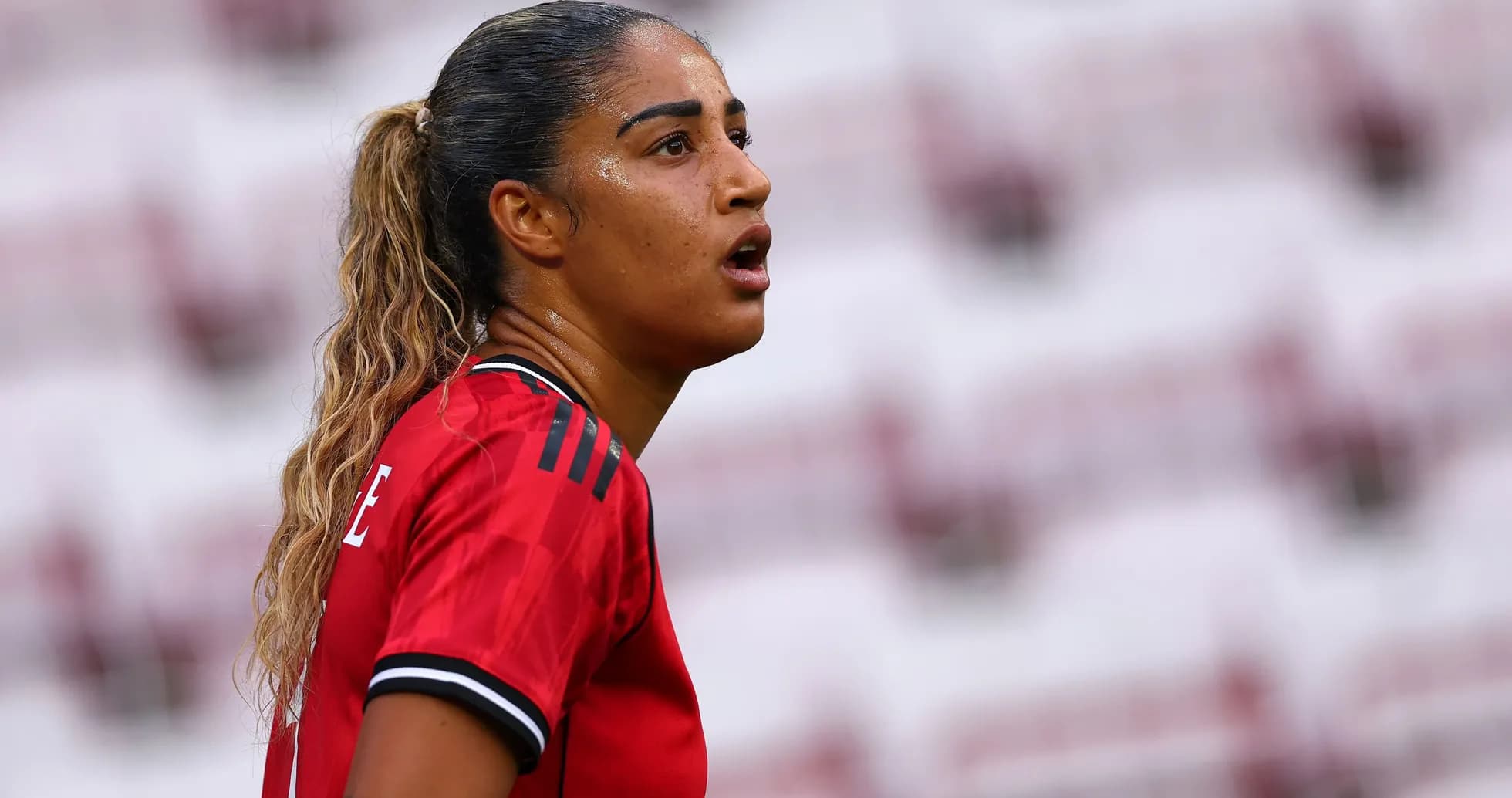 Player in red jersey during a match Player in red jersey during a match