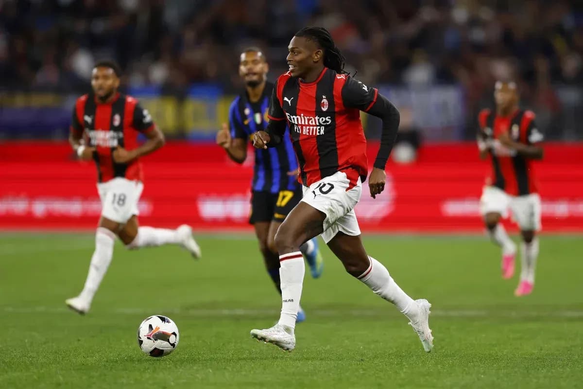 Player in AC Milan kit dribbling ball during match Player in AC Milan kit dribbling ball during match