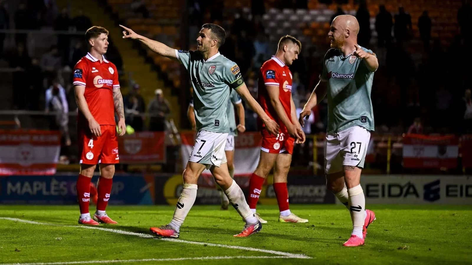 Players celebrating a goal during football match Players celebrating a goal during football match