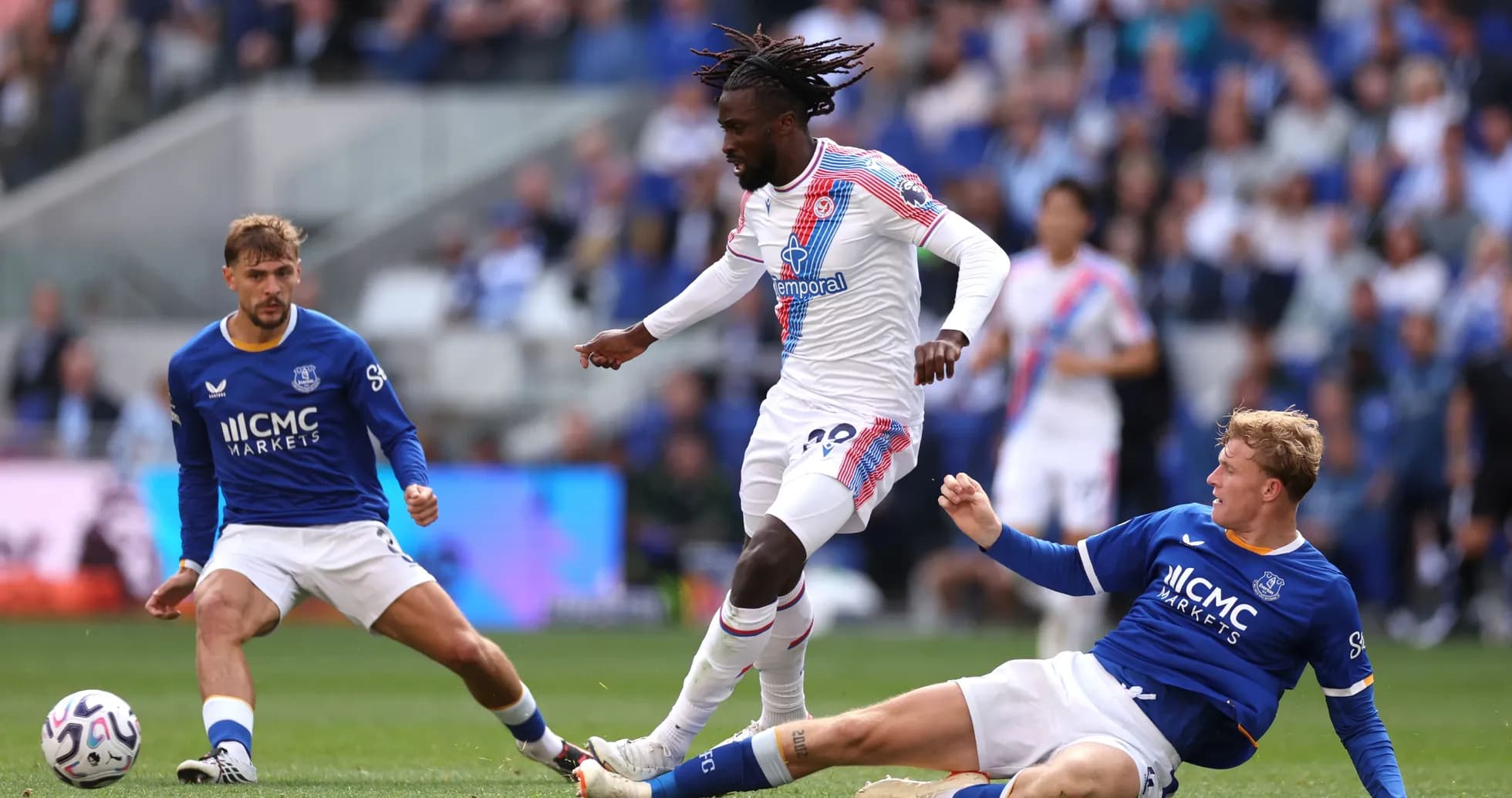 Player dribbling past two opponents during match Player dribbling past two opponents during match