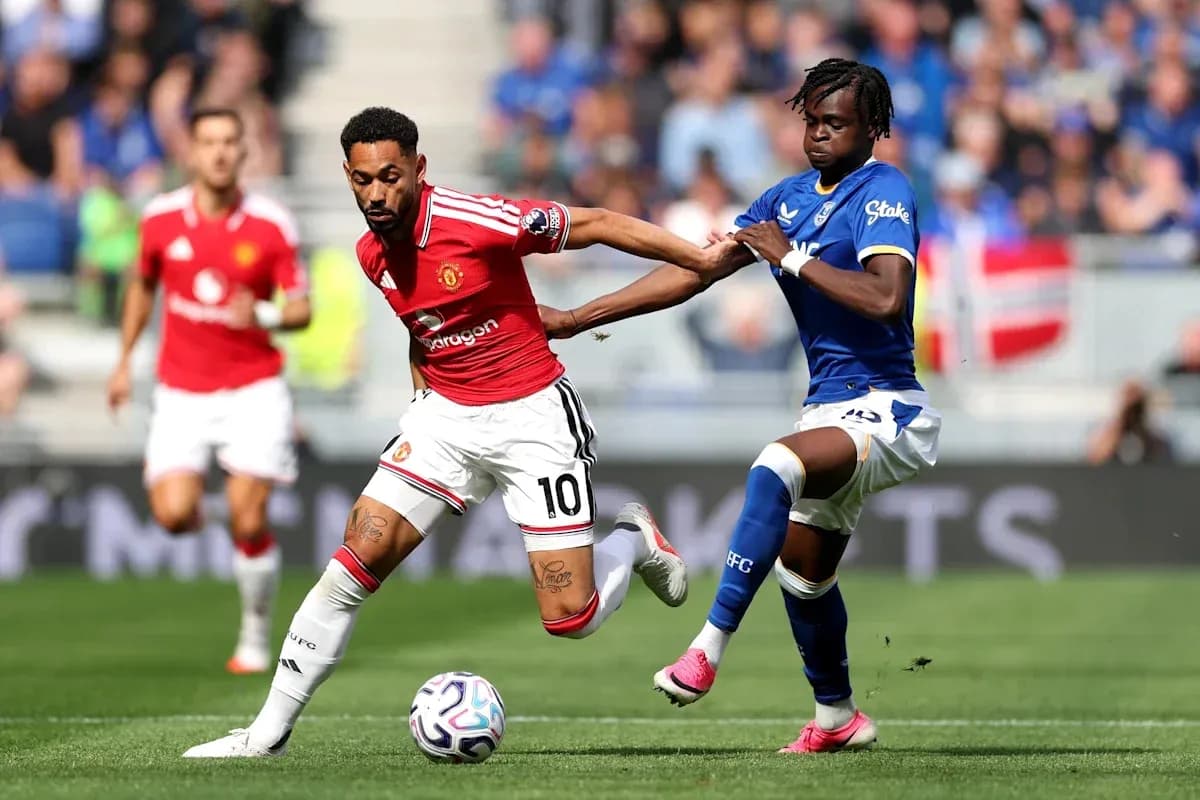 Player from Manchester United dribbling past Everton defender Player from Manchester United dribbling past Everton defender