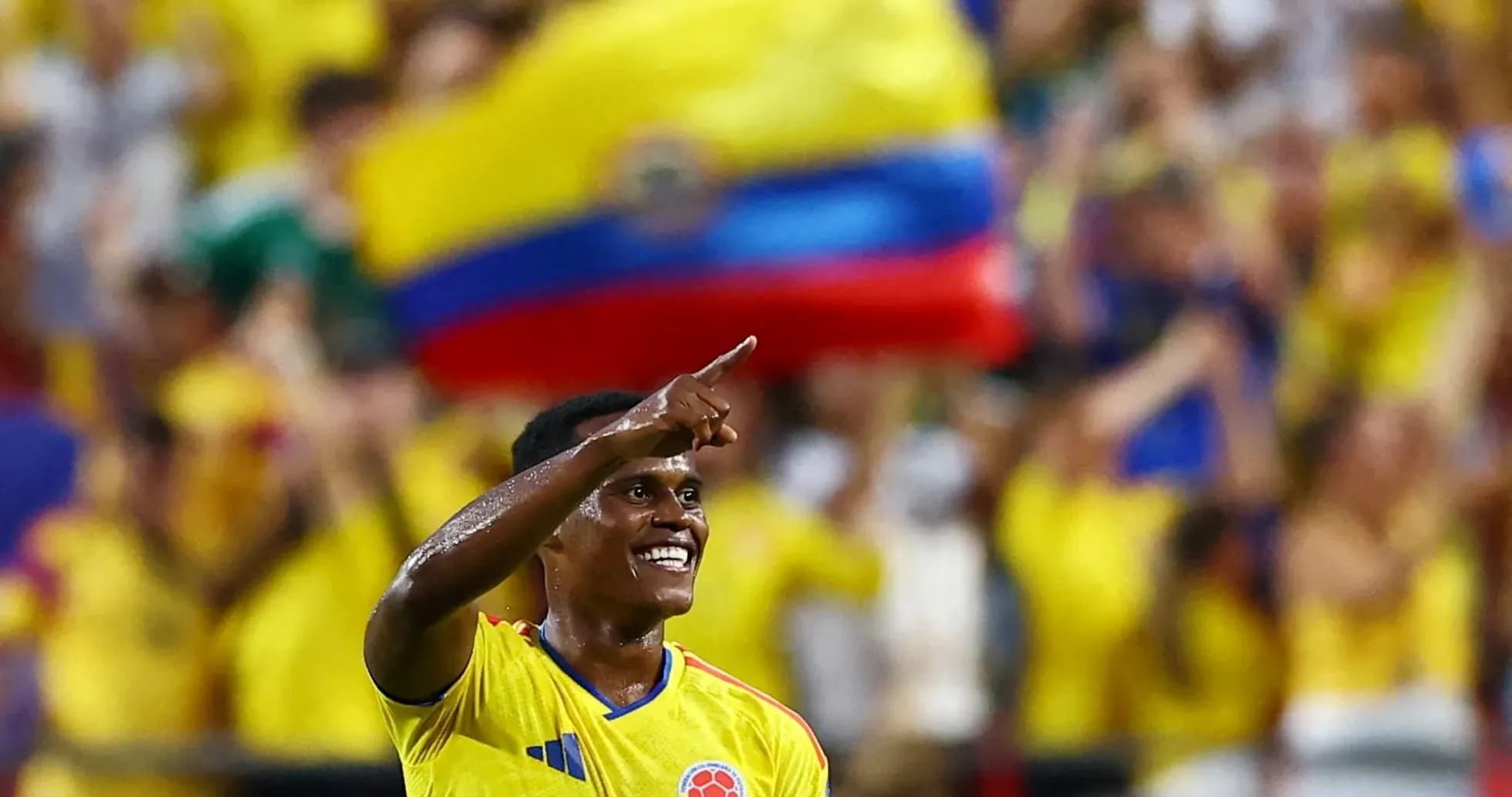 Player celebrating a goal with fans in background Player celebrating a goal with fans in background