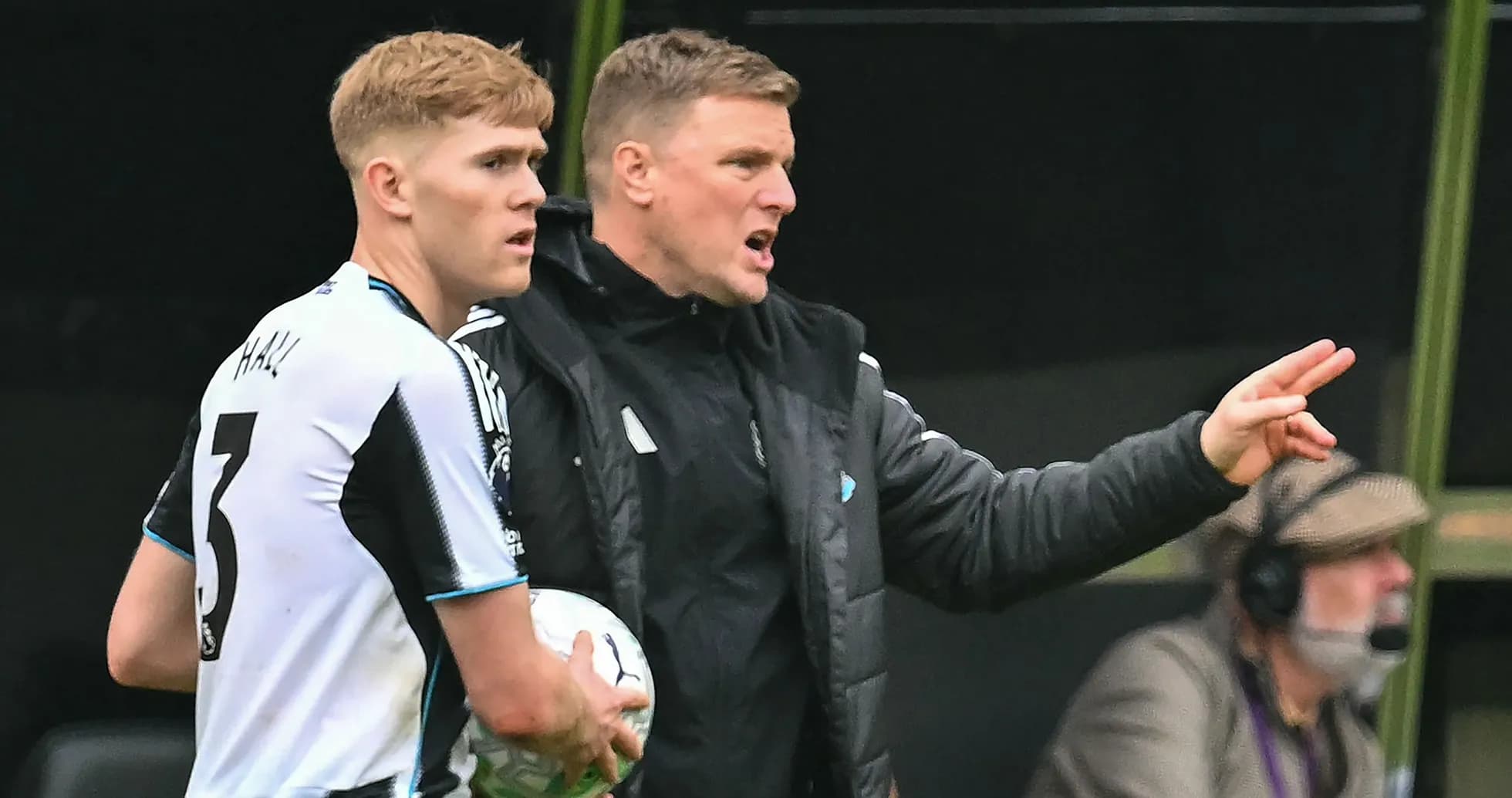 Newcastle player receiving instructions from coach during match Newcastle player receiving instructions from coach during match
