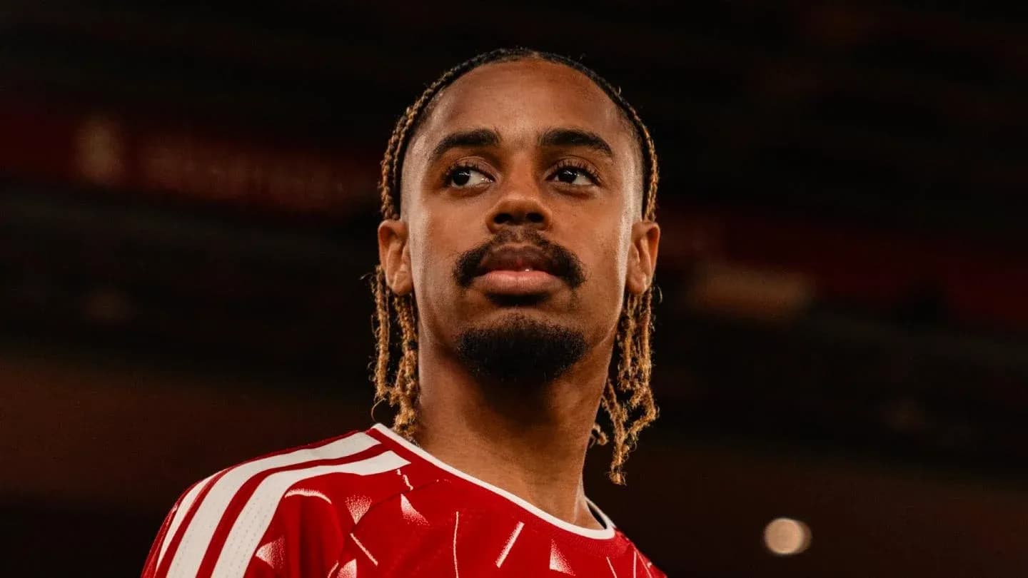 Player wearing red jersey looking off-camera Player wearing red jersey looking off-camera