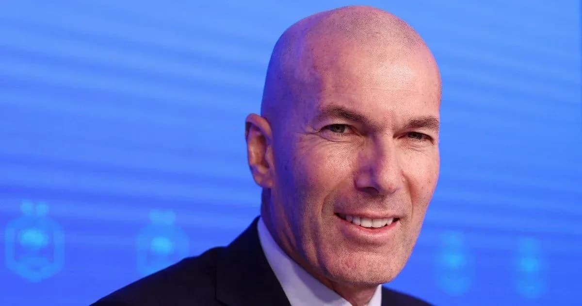 Man smiling at press conference with blue background Man smiling at press conference with blue background