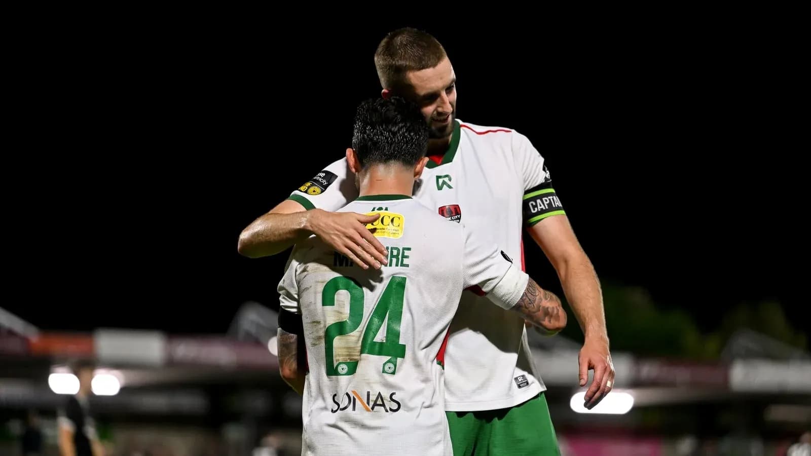 Two players embracing on the field after match Two players embracing on the field after match