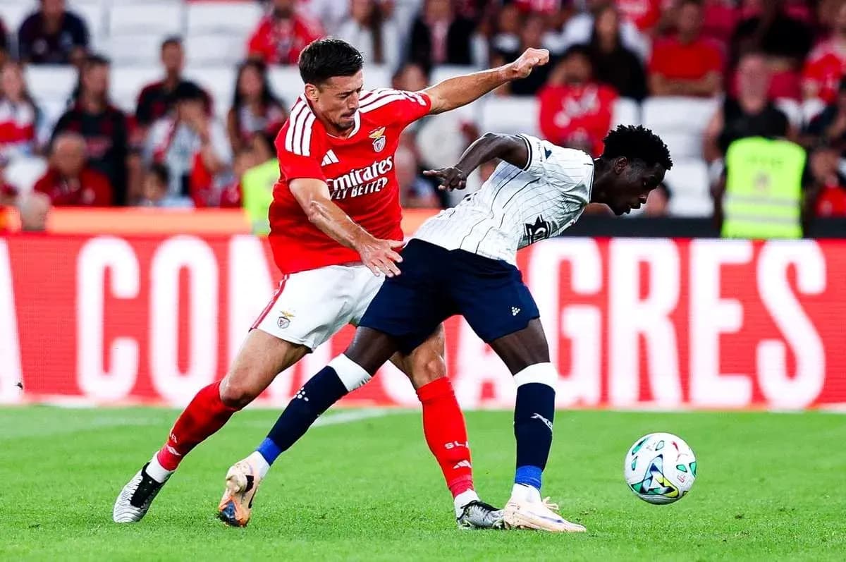 Benfica player challenges Aarhus opponent for the ball Benfica player challenges Aarhus opponent for the ball