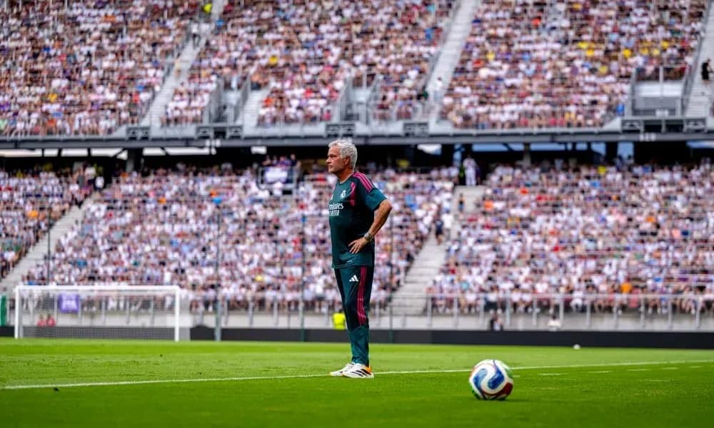 Coach standing on sideline during crowded match Coach standing on sideline during crowded match