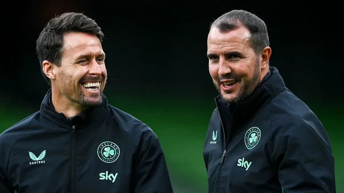 Two coaches smiling during a training session Two coaches smiling during a training session