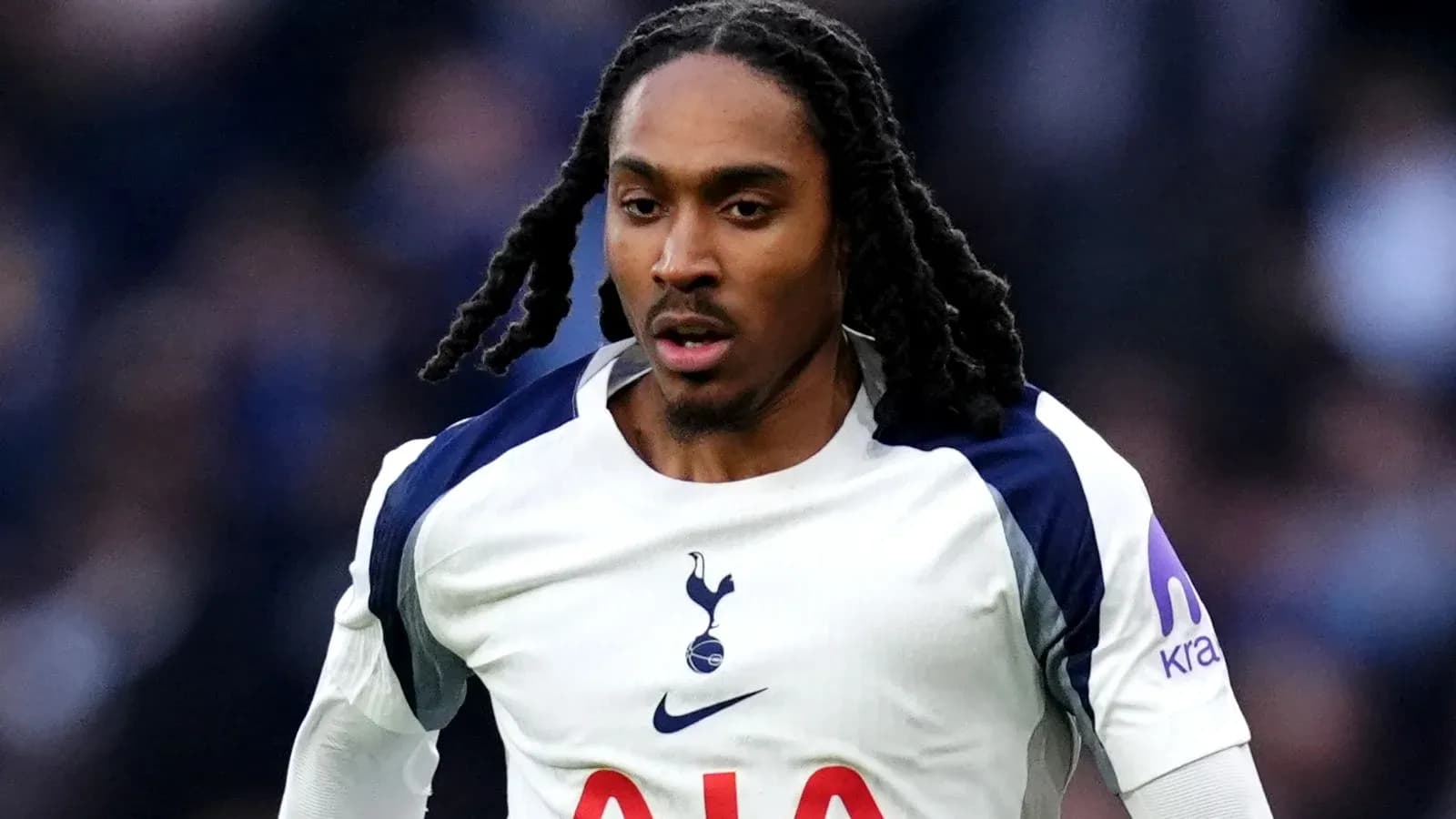 Player in Tottenham jersey running on the pitch Player in Tottenham jersey running on the pitch