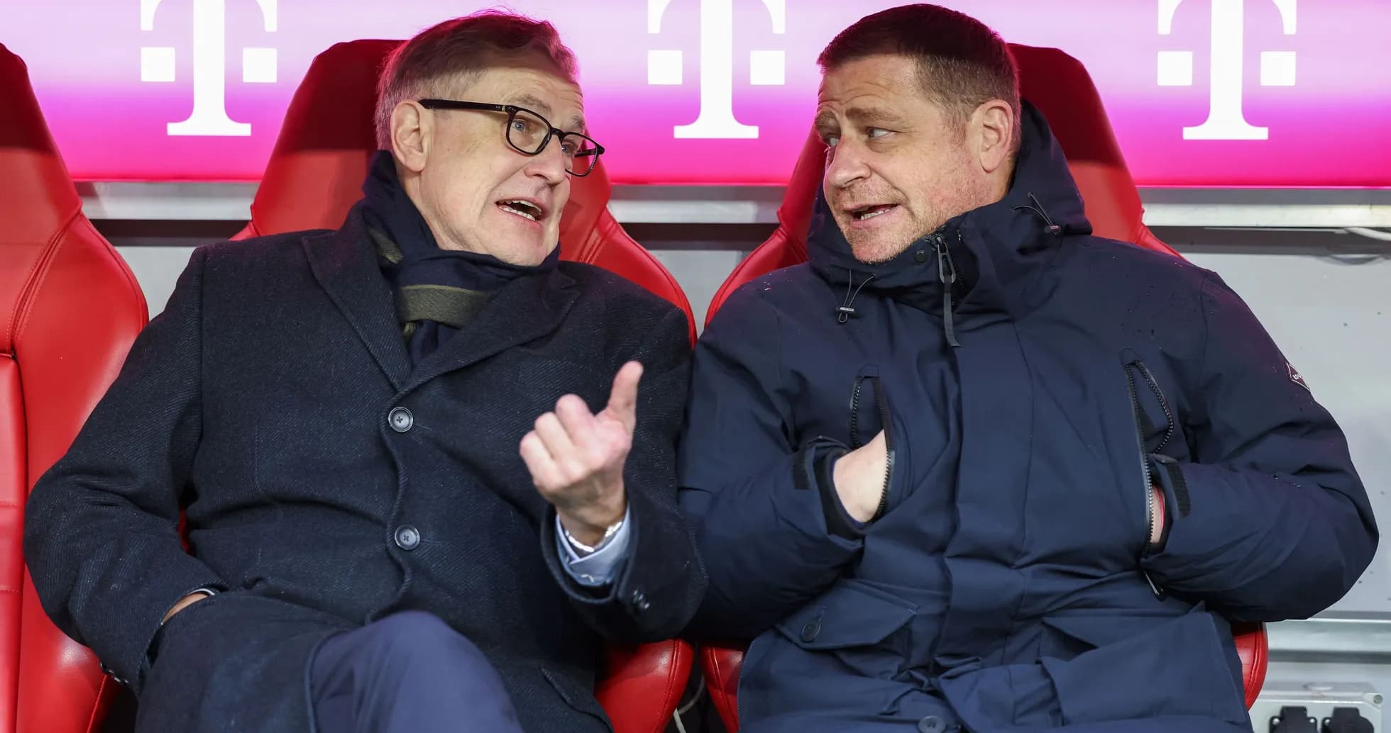 Two men seated on bench discussing during match Two men seated on bench discussing during match
