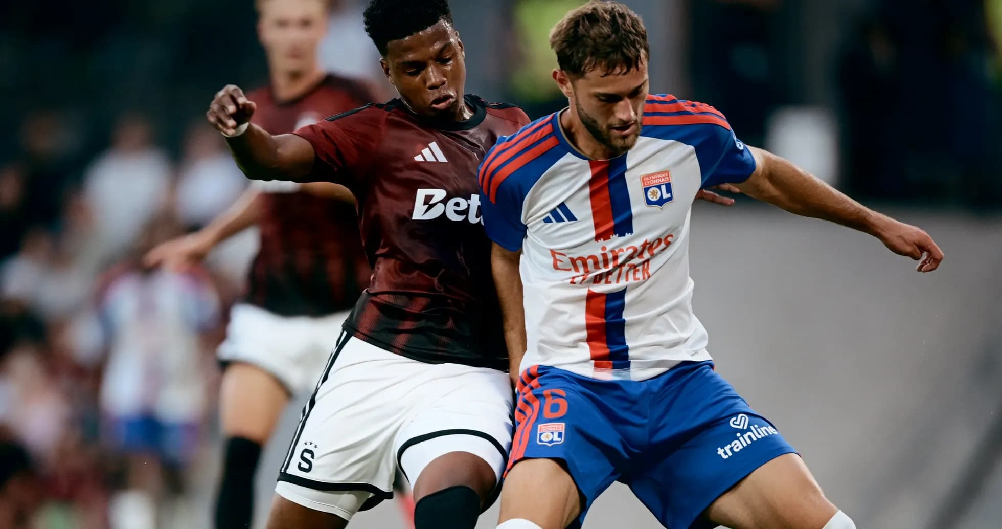 Lyon player battling against Sparta Praha opponent Lyon player battling against Sparta Praha opponent