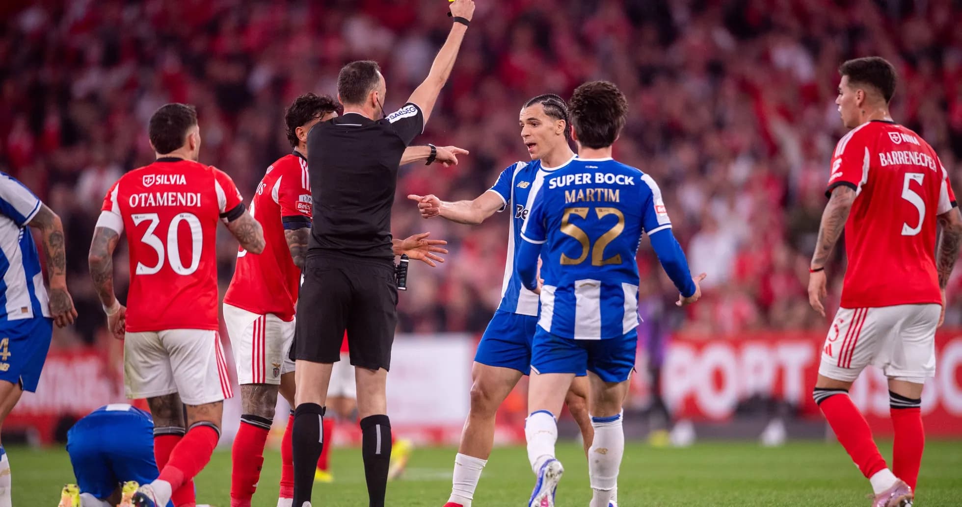 Referee showing yellow card during heated match moment Referee showing yellow card during heated match moment