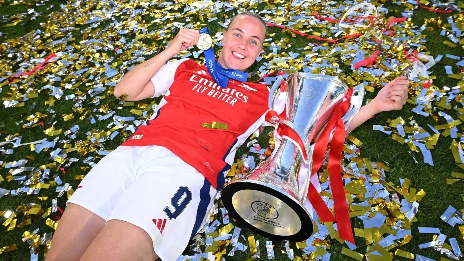Player celebrating with trophy and medal on field Player celebrating with trophy and medal on field