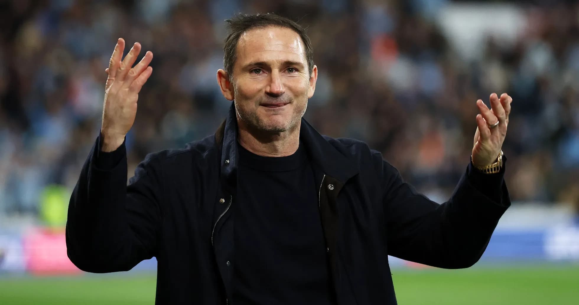 Manager gesturing to fans after match conclusion Manager gesturing to fans after match conclusion