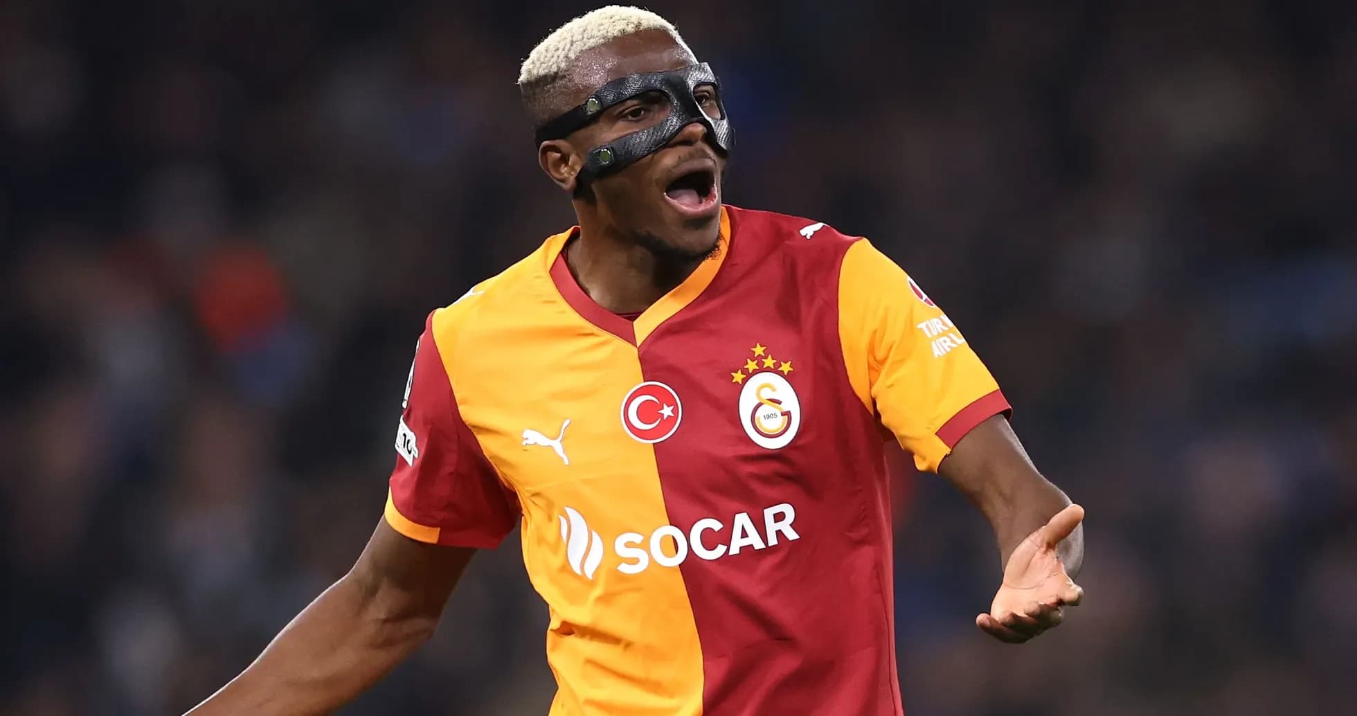 Player celebrating while wearing a protective mask Player celebrating while wearing a protective mask