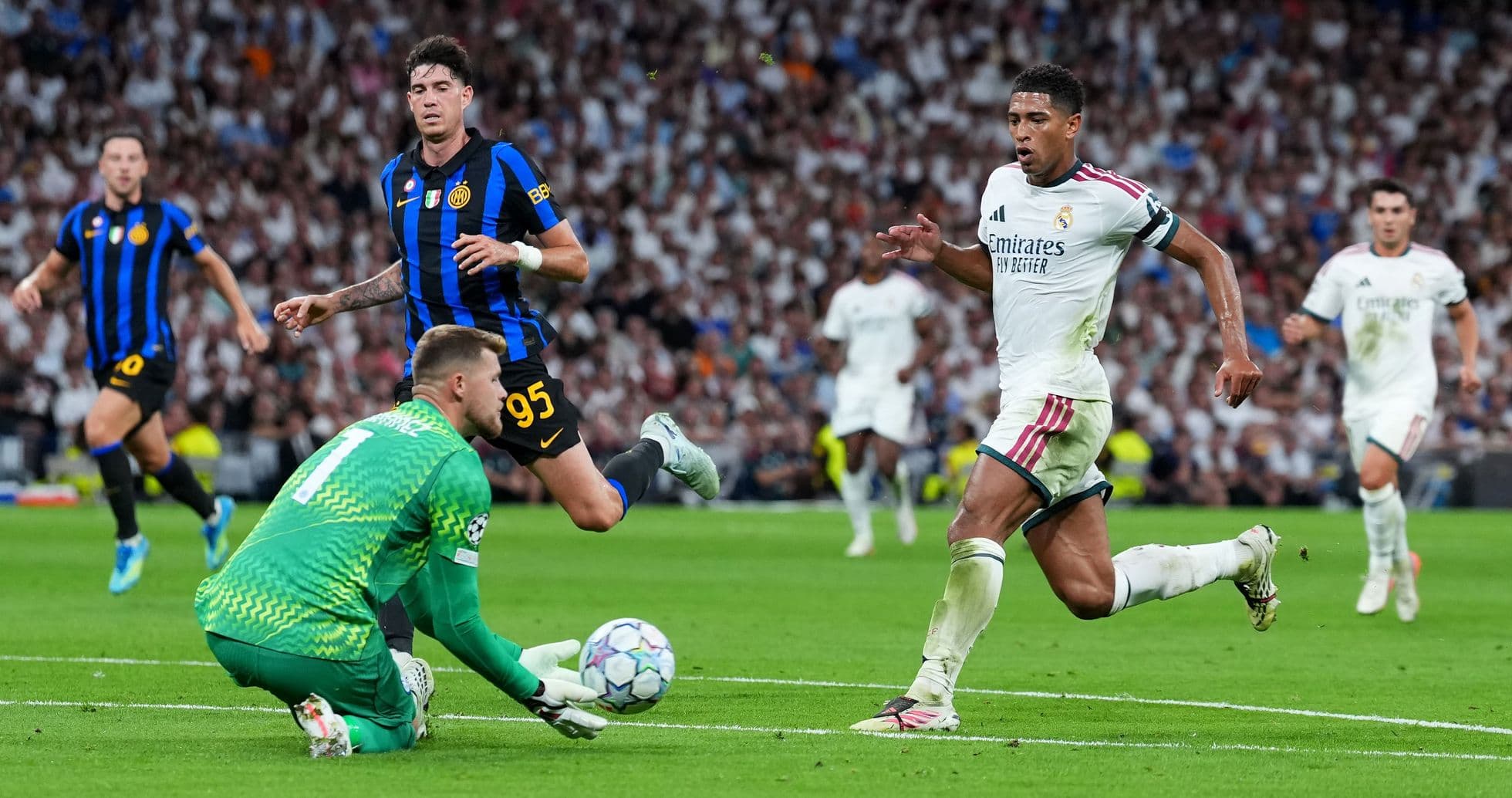 Real Madrid player running past goalkeeper during match Real Madrid player running past goalkeeper during match