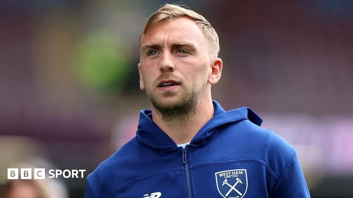 Player wearing West Ham United hoodie on pitch Player wearing West Ham United hoodie on pitch