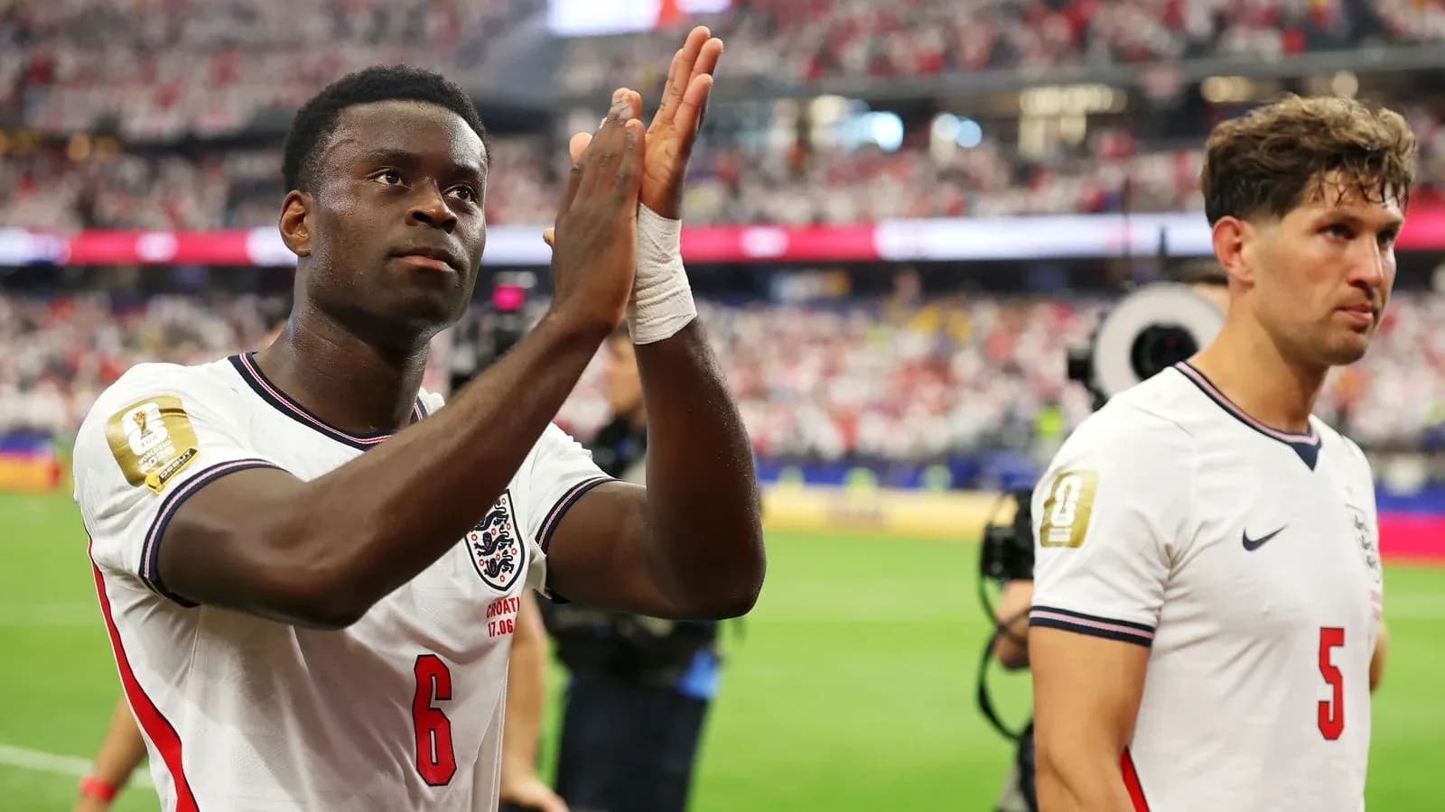 Two England players acknowledging fans after match Two England players acknowledging fans after match