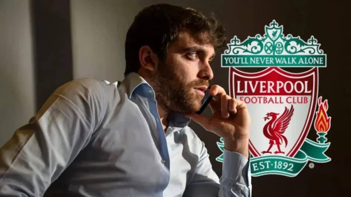 Person on phone with Liverpool FC logo in background Person on phone with Liverpool FC logo in background