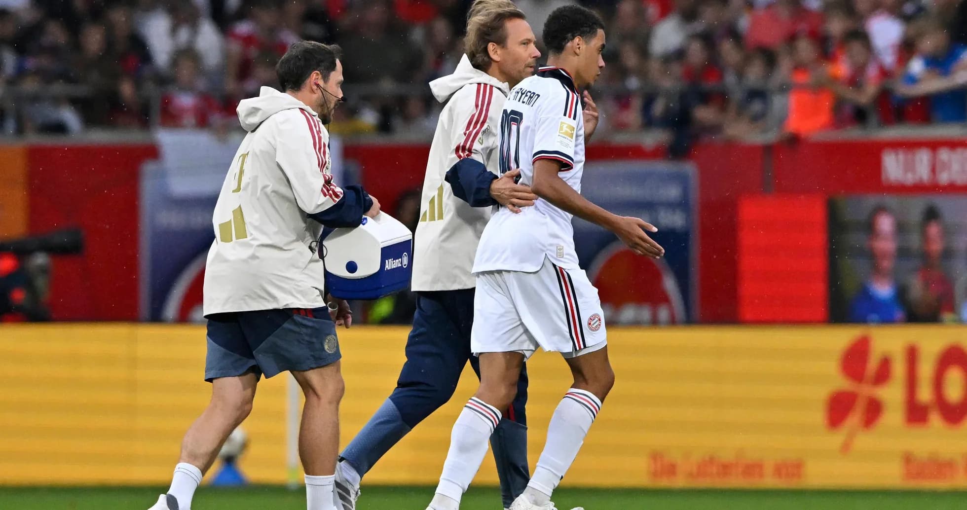 Player being assisted off the field by staff Player being assisted off the field by staff